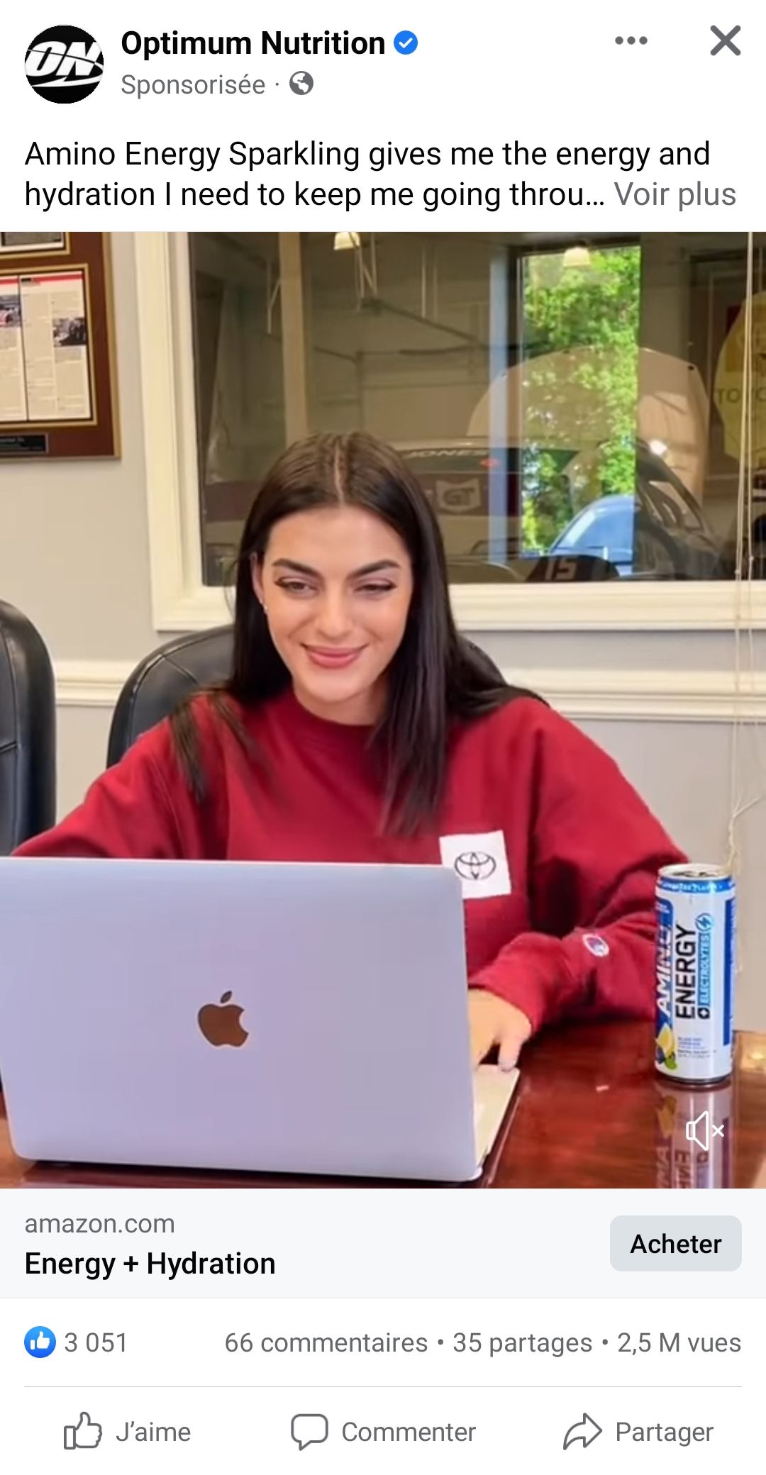 Screenshot of a video showing a woman working on a laptop with a energy drink